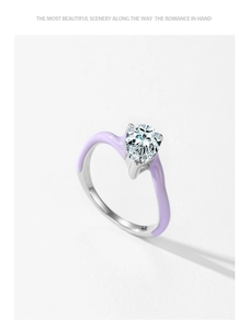 Detailed view of pear-cut sparkling zircon ring with violet enamel and silver band