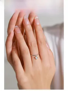 Detail of 925 sterling silver heart charm ring featuring sparkling zircon on hand