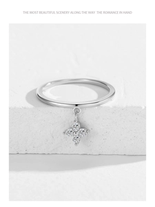 Macro detail of silver 925 clover pendant ring with sparkling stones on stone base
