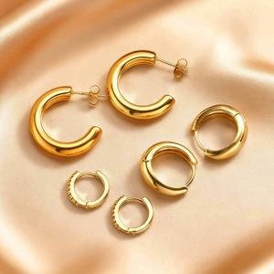Three-piece gold plated stainless steel hoop earring set with zircon on silk background