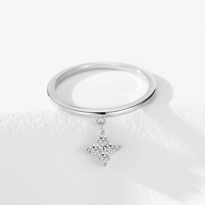 Sparkling 925 silver four-leaf clover pendant ring with clear zircon stones on white surface