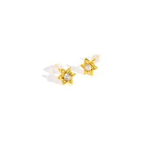 Détail d'un clou d'oreille étoile dorée avec zircon vert olive et fermoir silicone