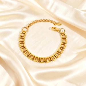 Macro view of minimalist golden rectangular link bracelet with Au750 engraved tag