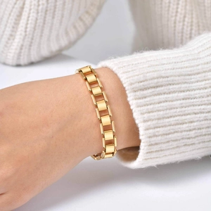 Minimalist golden stainless steel link bracelet worn on wrist for daily styling