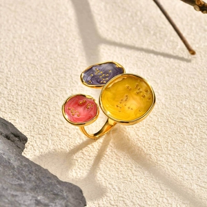 Golden geometric open ring featuring colorful enamel inlay with subtle sand texture