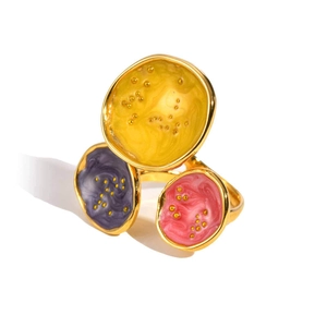 Detail of gold-plated geometric ring with yellow, purple, and pink enamel inlay work
