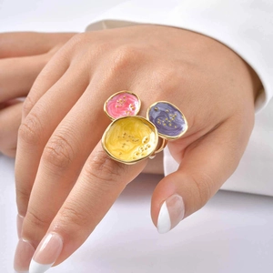 Macro detail of gold geometric ring featuring colorful enamel Mickey-shaped design