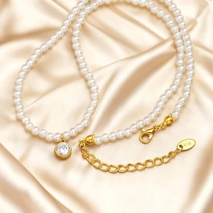 Detailed macro view of 18K gold plated K18 hallmark tag on pearl necklace with zircon pendant