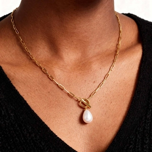 Golden paperclip chain necklace featuring a toggle clasp and water drop pearl pendant
