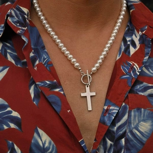 Men's pearl necklace featuring a stainless steel cross pendant and OT clasp on a male model