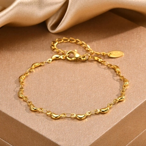 18K gold-plated stainless steel dolphin bracelet with polished bean charms and lobster clasp