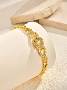 Detailed view of gold-plated cuban chain bracelet with interlocking pave zircon ovals