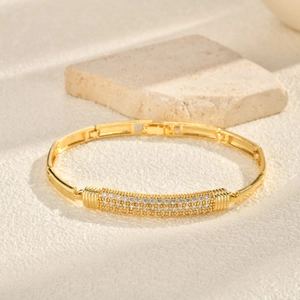 Detail of gold-plated heart bracelet featuring three rows of pave-set cubic zirconia