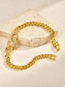 Macro detail of gold-plated Cuban link bracelet featuring three micro-set zircon oval links