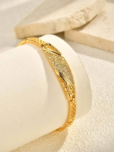 Detail of 24K gold elephant bangle featuring hollow patterns and white zircon pavé