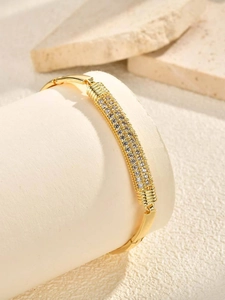 Detailed view of the gold heart bracelet with triple rows of pavé zircons on display
