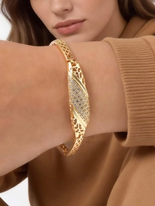 Detailed close-up of 24K gold plated elephant bracelet with white sparkling crystals