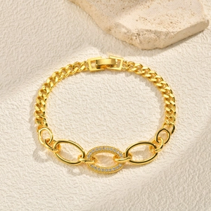 Macro detail of gold-plated cuban link bracelet with micro-pave cubic zirconia accents