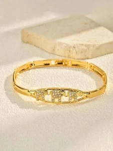 Detail of 24K gold plated elephant bracelet with sparkling zircons on bamboo link chain