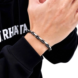 Close-up of men's two-tone stainless steel cuban chain bracelet in silver and black finish