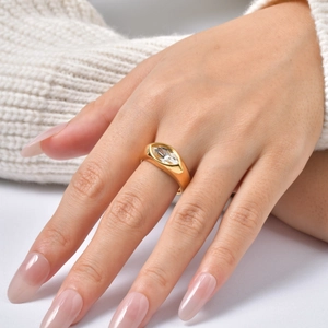 Detailed view of marquise-cut white zircon ring on hand with white knit sweater