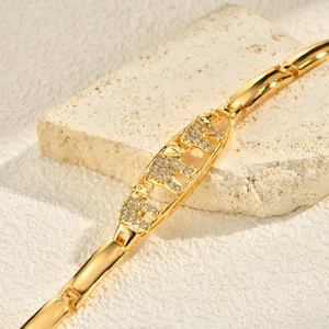 Detailed macro view of 24K gold elephant bracelet with sparkling micro-pave crystals