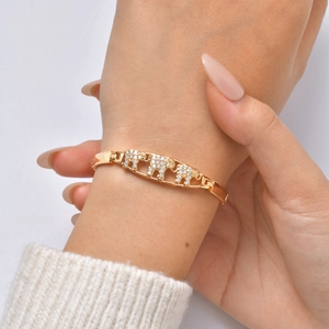 Close-up of a 24K gold-plated bamboo bracelet featuring a sparkling crystal elephant motif
