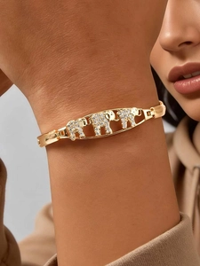 Macro shot of 24K gold plated elephant link bracelet with sparkling zircon stones