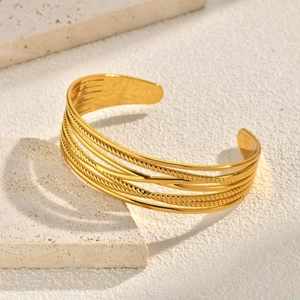 Wide gold minimalist open bangle with layered twisted rope and smooth metal geometric design