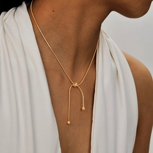 Adjustable golden stainless steel snake chain necklace with round beads on model