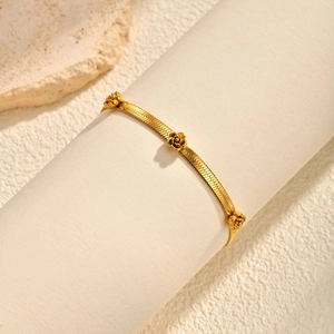 Gold stainless steel snake chain bracelet featuring three delicate carved rose flower charms