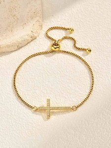 Detail of adjustable gold box chain bracelet with sparkling cubic zirconia cross element