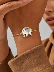 Detailed close-up of a golden elephant charm bracelet with colorful zircon and white enamel