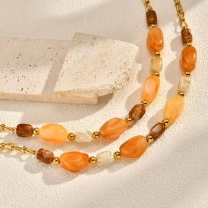 Elegant multi-layered gold chain necklace with amber resin beads and marble patterns