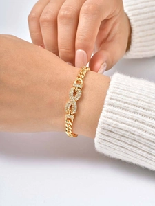 Detail of 24K gold plated infinity bracelet featuring cubic zirconia and Cuban links