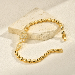 Detailed macro view of 24K gold plated infinity link bracelet with pavé cubic zirconia