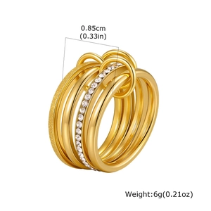Detail of multi-layered gold ring featuring sparkling pavé crystals and sandblasted texture