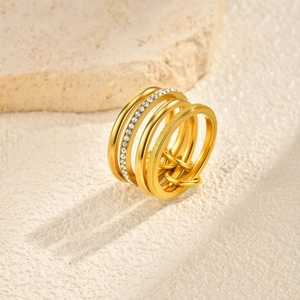 Detailed macro view of multi-layered gold ring with rhinestone inlay and matte texture