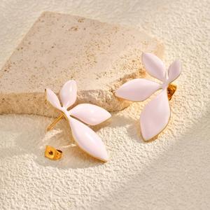 Detail of leaf stud earrings with light pink enamel and gold metal edges on stone
