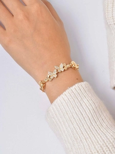 Detailed view of a 24K gold plated butterfly bracelet with pavé cubic zirconia accents