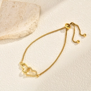 Detail of adjustable gold box chain bracelet featuring interlocking double hearts