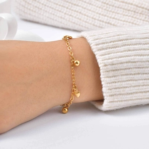 Elegant gold stainless steel bead chain bracelet with heart charm on female wrist