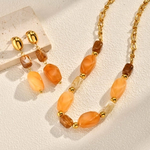 Golden irregular oval resin necklace and earrings set with amber and marble texture