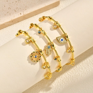 Three-piece gold snake chain bracelet set with Hamsa hand and evil eye zircon charms