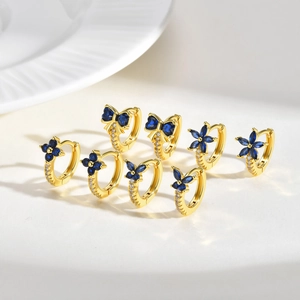 Dainty gold earrings set featuring blue zircon flower and butterfly designs