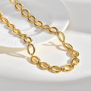 Detailed close-up of a polished gold stainless steel chunky oval link chain necklace