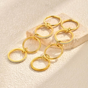 Gold multi-tier interlocking circle drop earrings with white pavé crystal accents