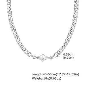 Detail showing silver Cuban chain width and geometric pendant with clear gemstone
