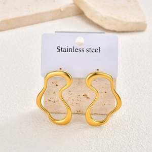 Detailed macro view of gold-plated irregular geometric stainless steel earrings on display
