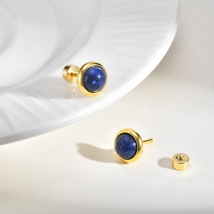 Macro detail of deep blue lapis lazuli stud earrings with secure gold screw back design